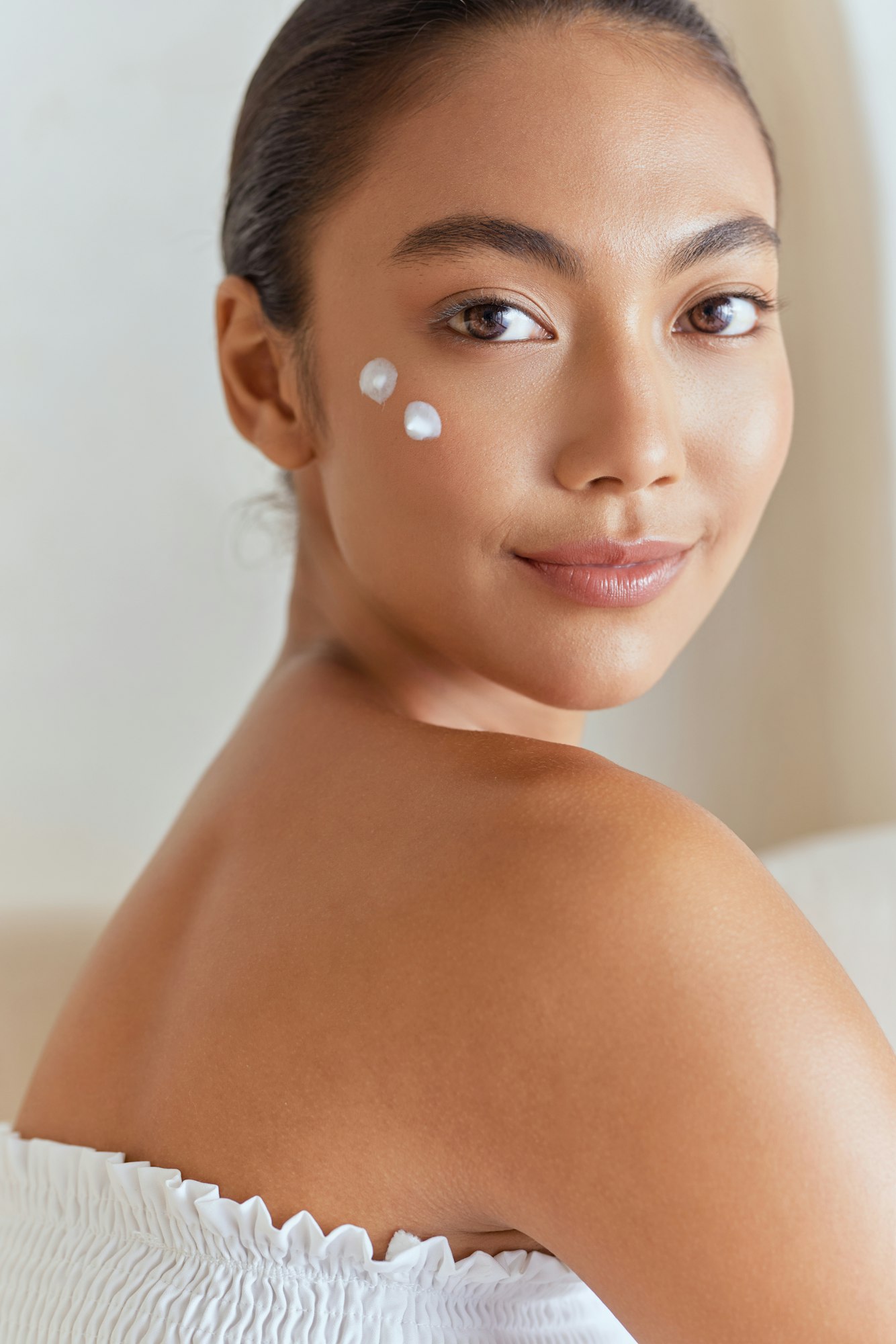 Natural Beauty. Woman Smiling With Skincare Cream On Face For Beauty Routine